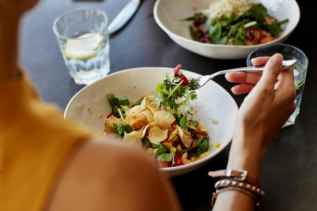 Hyatt Place Jaipur Malviya Nagar Bagian luar foto A woman eating a salad